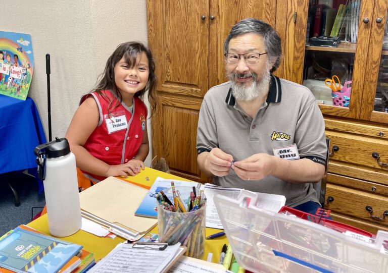 An Awana leader and a young clubber at the craft table