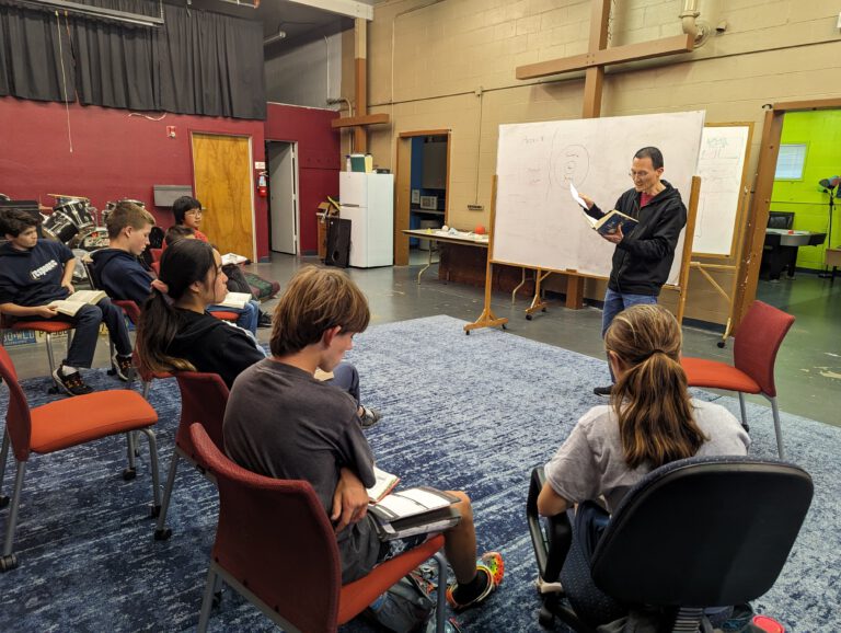 Older students sitting in a circle for a Bible teaching session